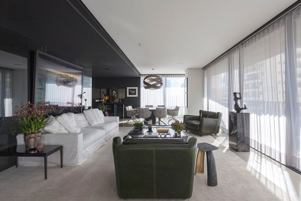 Madeira ebanizada e tons off white criam contraste em apê cheio de design