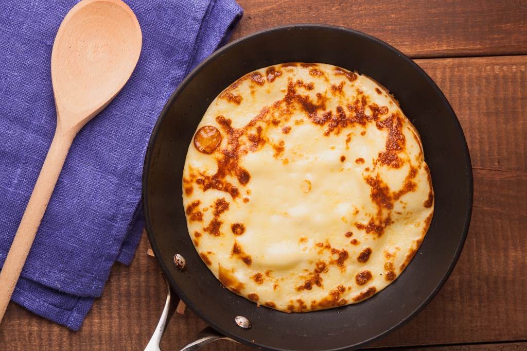 Homemade,Pancakes,On,A,Frying,Pan,With,Wooden,Spoon,Cream