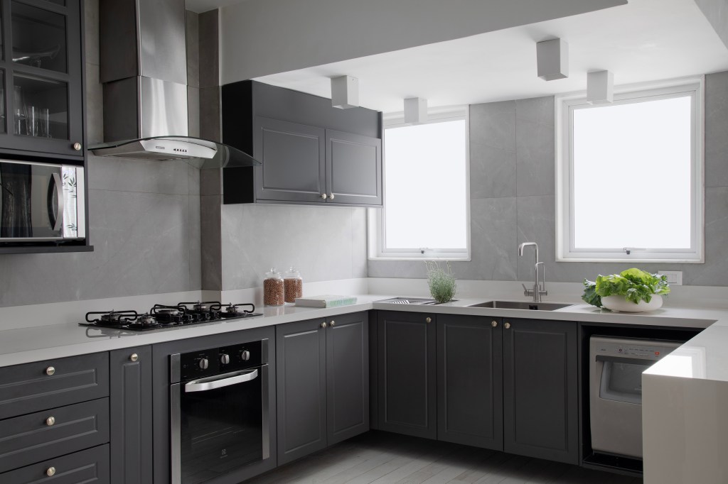 Com paleta sóbria, cobertura ganha cozinha cinza e sala íntima