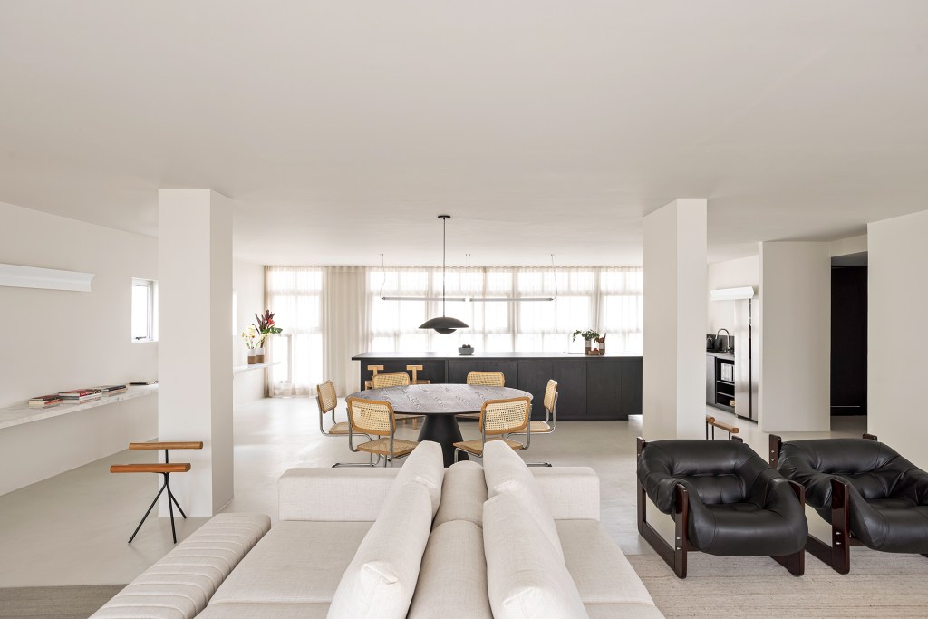 retrofit-predio-centro-sp-vence-monocle-design-awards-metro-arquitetos-credito-fran-parente (15) Retrofit de prédio no centro de SP vence Monocle Design Awards 2024. Projeto de Metro Arquitetos. Na foto, sala com cozinha integrada e sofás.
