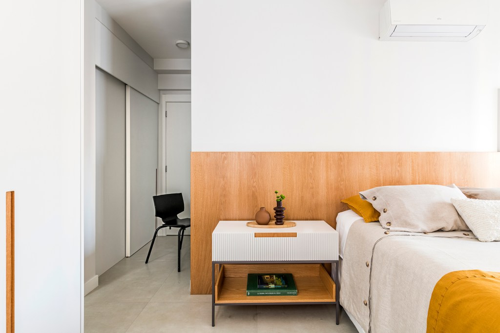 dois-escritorios-ampla-area-receber-caracterizam-ape-175-m2-juliana-casadei-credito-renato-navarro (28) Dois escritórios e ampla área de receber caracterizam apê de 175 m². Projeto de Juliana Casadei. Na foto, quarto de casal com cabeceira de madeira, quadro e mesinhas.